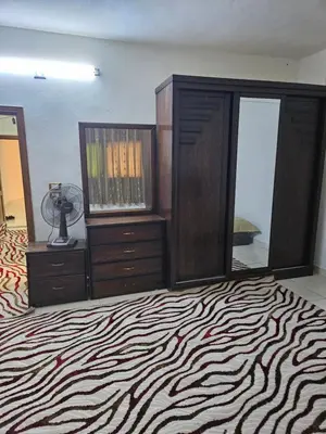 a bedroom with a bed and a dresser and a mirror at غصن الزيتون in Ajloun
