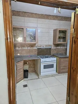 a kitchen with a stove and a counter top at غصن الزيتون in Ajloun