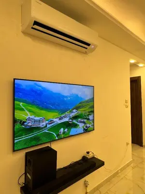 a flat screen tv hanging on a wall at شقة مفروشه فاخرة للايجار الاردن عمان in Amman