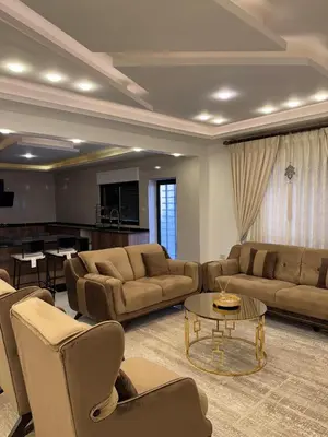 a large living room with couches and a table at شقة مفروشه فاخرة للايجار الاردن عمان in Amman