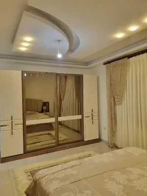 a bedroom with a large mirror and a bed at شقة مفروشه فاخرة للايجار الاردن عمان in Amman
