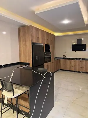 a kitchen with a black counter top in a room at شقة مفروشه فاخرة للايجار الاردن عمان in Amman