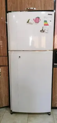 a white refrigerator with magnets and papers on it at A big Family nice sunset flat in Amman