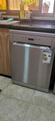 a dishwasher sitting under a counter in a kitchen at A big Family nice sunset flat in Amman