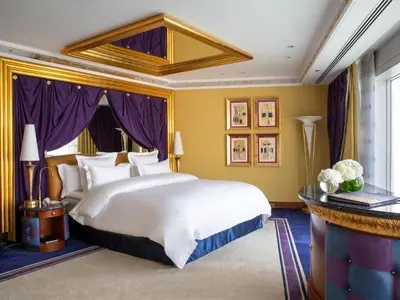 a bedroom with a large white bed and purple curtains at الأردن عمان in Irbid