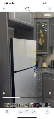 a kitchen with a white refrigerator in a kitchen at فيلا مفروشه ومزرعه للايجار in Jerash