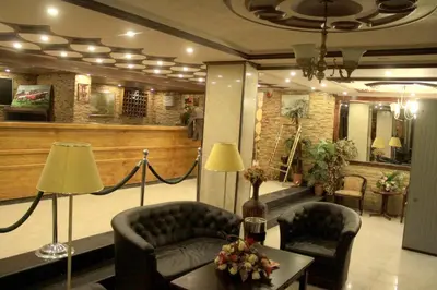 a lobby with two chairs and a couch and a table at CITYRISEHOTELINAMMAn in Al Jafr