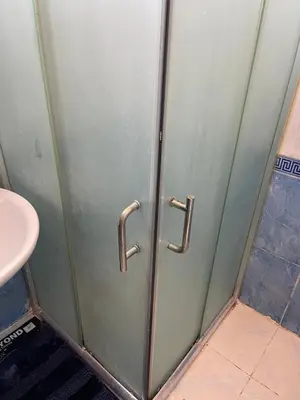 a metal door in a bathroom with a sink at Furnished one bedroom apartment in Amman