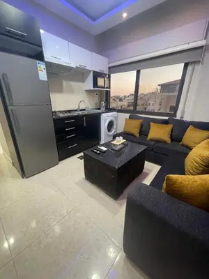 a large living room with a couch and a kitchen at apartment 60m 1bedroom for rent4 in Amman