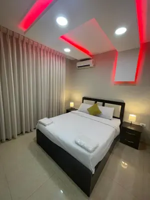a bedroom with a large bed with red lighting at apartment 60m 1bedroom for rent4 in Amman