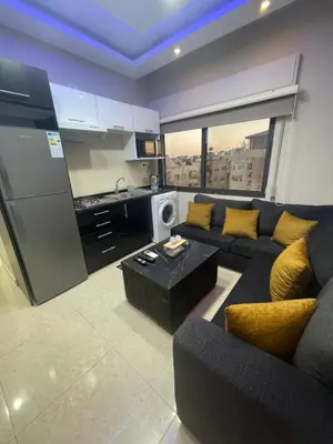 a large living room with a couch and a kitchen at apartment 60m 1bedroom for rent4 in Amman