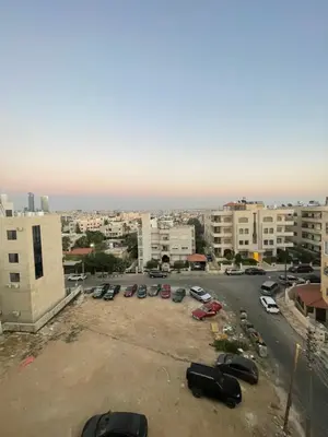 a parking lot with parked cars in a city at apartment 60m 1bedroom for rent4 in Amman