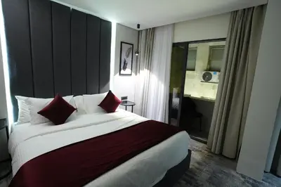 a hotel room with a large bed with red pillows at Roya Downtown Boutique Hotel in Amman