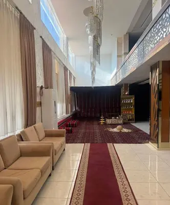 a living room with couches and a large stage at Althemar Hotel Ajloun -Jordan By Enala Hotels Group in Ajloun