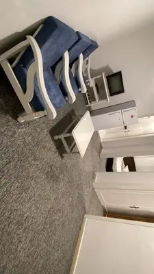 a room with a desk and a table with a blue cloth at aljumirah furnished appartments الجميرا للشقق المفروشة in Az Zarqa