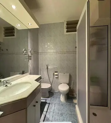 a bathroom with a sink and a toilet and a shower at Tea apartment in Aqaba