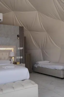 a bedroom with two beds in a tent at Bubble Camp Wadi Rum in Wadi Rum