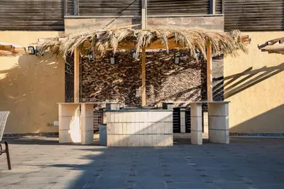 a building with a straw roof on the side of it at Bahama-Oriya chalets in Al Rama