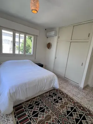 a bedroom with a white bed and a rug at White castle in Aqaba