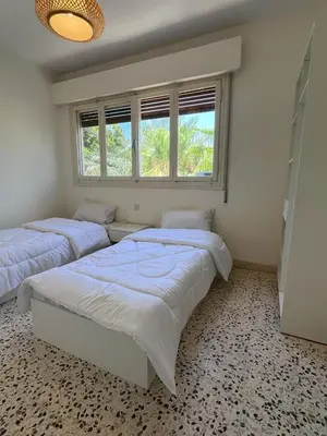 a bedroom with two beds and a window at White castle in Aqaba