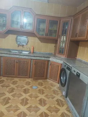 a kitchen with a sink and a washing machine at عجلون in Ajloun
