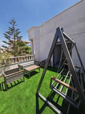 a group of benches in a yard next to a building at بيت محمد in Amman