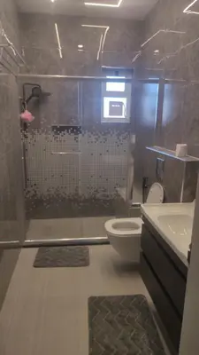 a bathroom with a shower and a toilet and a sink at بيت محمد in Amman