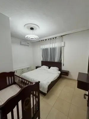 a bedroom with a bed and a window at stay by university of Jordan in Amman