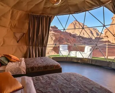 a room with two beds and a view of the desert at Celestial Mirage Camp in Wadi Rum