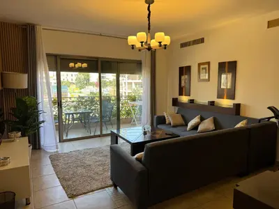 a living room with a couch and a table at Glow and Grace in Abdoun Best location in Amman