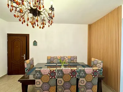 a dining room with a table and chairs and a chandelier at Loom & Light In the best location in Abdoun Amman in Amman