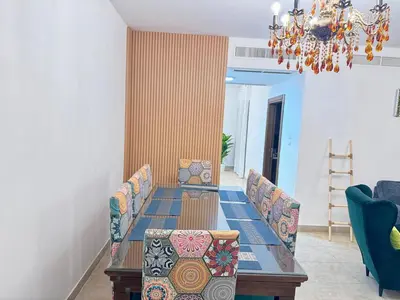 a dining room with a table and chairs and a chandelier at Loom & Light In the best location in Abdoun Amman in Amman