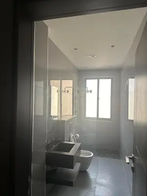 a bathroom with a sink and a toilet at Masaken Hotel Apartment in Amman