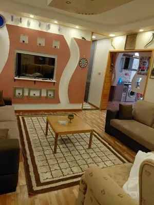 a living room with a couch and a coffee table at روف بانورامي باطلاله رائعه يسمح فقط للبنات او زوج وزوجة العمارة عائلية in Amman