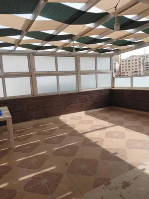 a large room with windows and a tiled floor at روف بانورامي باطلاله رائعه يسمح فقط للبنات او زوج وزوجة العمارة عائلية in Amman
