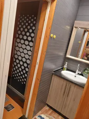 a bathroom with a sink and a shower at روف بانورامي باطلاله رائعه يسمح فقط للبنات او زوج وزوجة العمارة عائلية in Amman