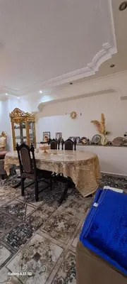 a living room with a large marble table and chairs at شقة مميزة in Rujm Maghghijhah