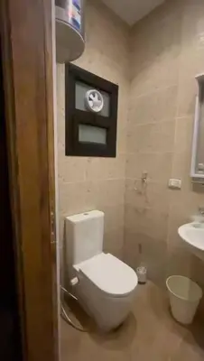 a bathroom with a white toilet and a sink at Ok apartment in Petra