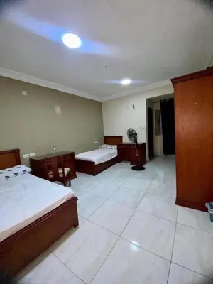 a large room with two beds and a table at Ok apartment in Petra