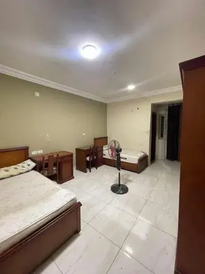 a bedroom with two beds and a fan in it at Ok apartment in Petra