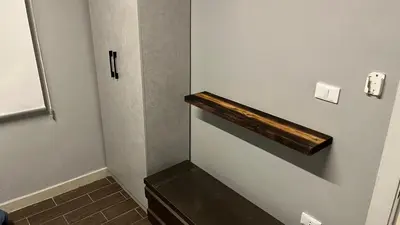 a small bathroom with a wooden shelf on the wall at T Cozy Chalet in Ash Shāghūr