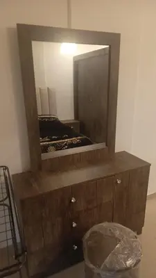 a mirror on top of a dresser in a room at lNTERCoNTlNENTALAL in Amman