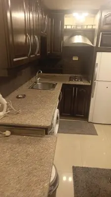 a kitchen with a sink and a counter top at lNTERCoNTlNENTALAL in Amman