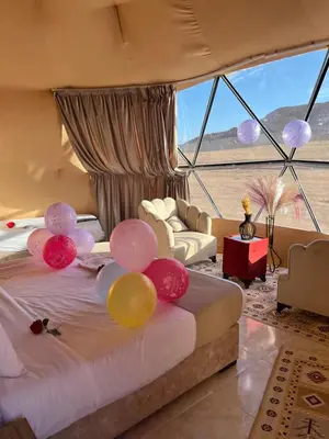 a room with a bed with balloons on it at DESERT BREATHS lUXURY CAMP in Wadi Rum