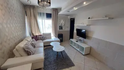 a living room with a couch and a tv at Nice cozy place in Amman