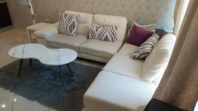 a living room with a white couch and a table at Nice cozy place in Amman