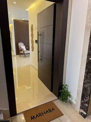 a large glass door in a hallway with a chair at The view in Māḩiş