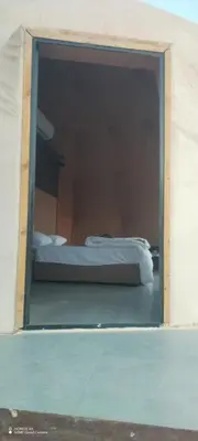 a window in a room with a bed in it at Shadow of Rum camp in Wadi Rum