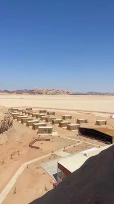 a group of buildings in the middle of a desert at Siq Rum Luxury Camp in Wadi Rum