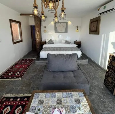 a bedroom with a bed and a couch in it at Siq Rum Luxury Camp in Wadi Rum